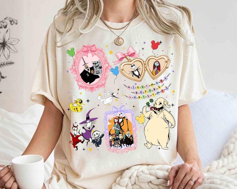 a person wearing a white t-shirt with various cartoon characters and designs, including a skeleton, a pumpkin, and other Halloween-themed elements.