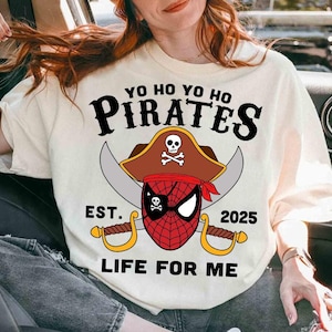 a woman sitting in a car wearing a shirt with a pirate on it