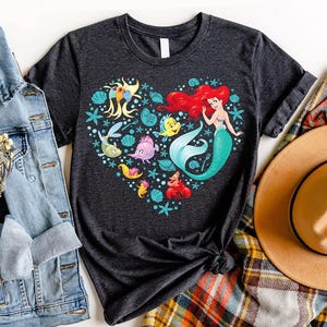 a t - shirt that has a mermaid heart on it