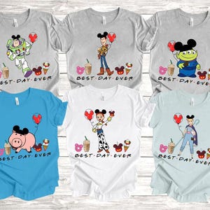 a group of mickey mouse shirts on a wooden table