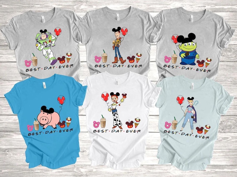 a group of mickey mouse shirts on a wooden table