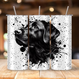 May include: A black and white illustration of a dog's head with paint splatters on a white background. The image is printed on a stainless steel tumbler.