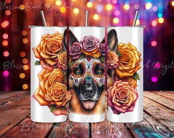 May include: A white tumbler with a colorful illustration of a German Shepherd dog with sugar skull makeup and a floral wreath. The dog is surrounded by orange and yellow roses.