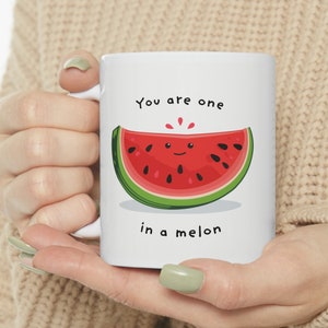 May include: White ceramic mug with a red watermelon slice graphic and the text "You are one in a melon".