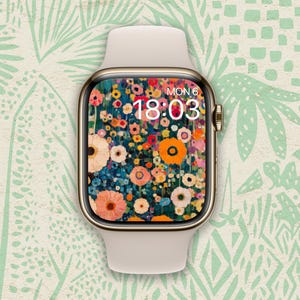 以下が含まれることがあります： 金色のバンドと花の文字盤が付いた白いApple Watch。文字盤には18:03とMON 6が表示されています。