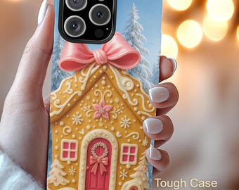 May include: A phone case featuring a gingerbread house design with a pink bow and a winter scene background. The case has a blue border and the text "Tough Case" is visible.