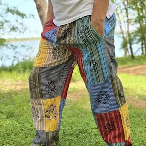 May include: Multicolored patchwork pants with a variety of patterns and symbols, including stripes, swirls, and geometric shapes. The pants are made of a soft, comfortable fabric and have a relaxed fit.
