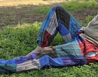 May include: Patchwork trousers with a variety of colours and patterns, including blue, red, green, and brown. The trousers have a loose fit and are made of a soft, comfortable fabric.