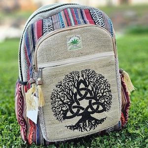 May include: A hemp backpack with a tree of life design and a colorful striped pattern. The backpack has a zippered pocket and a small tag that says "Himalayan Hemp Textiles Made in Nepal".