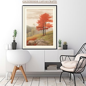 Puede incluir: Una impresión sobre lienzo enmarcada de una pintura de paisaje con tres árboles en primer plano. Los árboles tienen hojas rojas y se encuentran sobre un fondo de colinas onduladas y un cielo nublado.