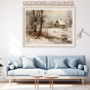 May include: A framed painting depicting a rustic cabin in a snowy winter scene. The cabin is brown with a white roof and is surrounded by trees and a stream. The painting is in a light wood frame.
