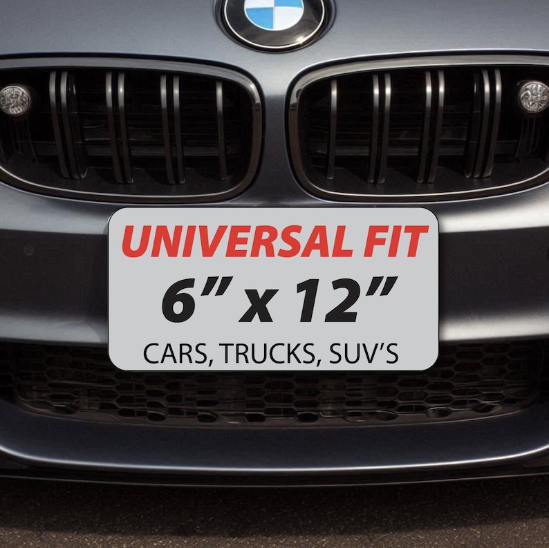 K&ouml;nnte beinhalten: Rechteckiges Nummernschild mit dem roten Text "UNIVERSAL FIT" und dem schwarzen Text "6" x 12"". Darunter steht "CARS, TRUCKS, SUV'S". Das Schild ist an der vorderen Sto&szlig;stange eines Autos angebracht. Ma&szlig;e ca. 15 cm x 30 cm.