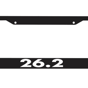 May include: Black license plate frame with white text that reads "26.2".