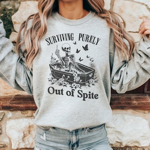Surviving Purely Out of Spite Skeleton Coffin Sweatshirt, Unisex Graphic Pullover Shirt, Funny Halloween Sweatshirt, Plus Size Salem Hoodie