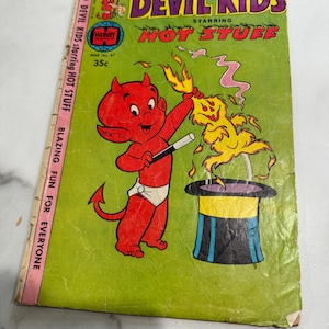 May include: Vintage comic book titled "Devil Kids" starring Hot Stuff. The cover features a red devil character with a magic wand, a yellow creature, and a top hat. The background is green with text that reads "Blazing Fun for Everyone."