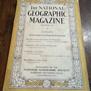 May include: A vintage National Geographic Magazine cover from October 1925. The cover is cream-colored with a gold border and features the magazine's title and issue details. The cover lists articles, including "The Romance of Science in Polynesia."
