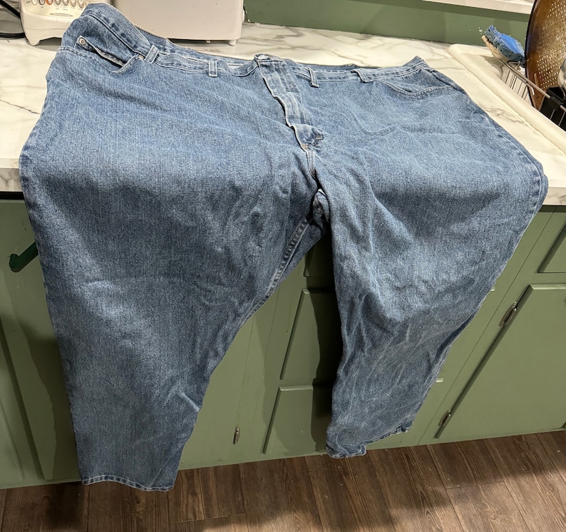 May include: A pair of blue denim jeans with a classic five-pocket style.