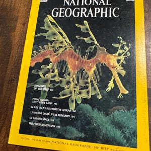 May include: A vintage National Geographic magazine from June 1978. The cover features a detailed illustration of a leafy seadragon against a dark background. The magazine's title and issue details are prominently displayed in yellow.