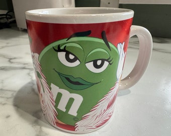 Green M & M Girl with a Feather and a Rose Coffee Mug