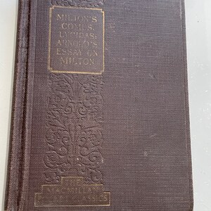 May include: A brown book with gold lettering on the cover. The title is "Milton's Complete Lycidas:  An Essay on Milton".