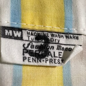 May include: White fabric with yellow and blue stripes. A white tag with black text reads "MW Machine Wash Warm Tumble Dry Fashion Manor Percale Penn-Prest".