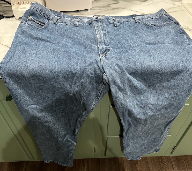 May include: A pair of blue denim jeans with a classic straight leg fit.
