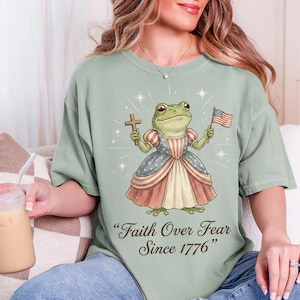 Camiseta cristiana de 250 años, fe patriótica, libertad, 1776-2026, Una nación bajo Dios, EE. UU., 250 aniversario, bandera estadounidense, cruz, julio, regalos de rana