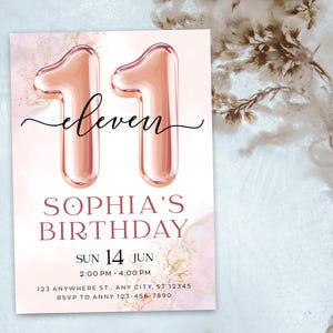 May include: A birthday invitation with a pink and gold watercolor background. The number "11" is displayed as rose gold balloon-style numerals. The word "eleven" is written in cursive above "Sophia's Birthday". The date and time are also included.