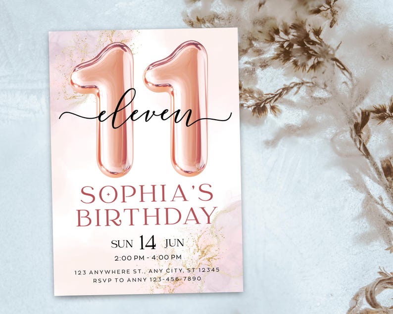 May include: A birthday invitation with a pink and gold watercolor background. The number "11" is displayed as rose gold balloon-style numerals. The word "eleven" is written in cursive above "Sophia's Birthday". The date and time are also included.