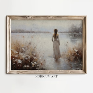May include: A framed landscape painting depicts a woman standing in a body of water, facing away from the viewer. The artwork features muted tones of beige, gray, and brown, with tall grasses and a distant shoreline. The text "NORICUM ART" is visible.
