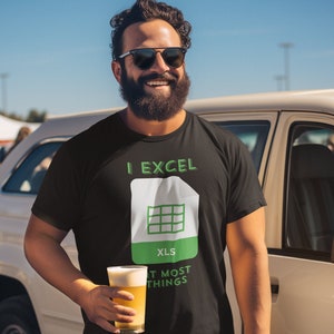 May include: A black t-shirt with a green and white graphic of a spreadsheet icon and the text "I EXCEL AT MOST THINGS".