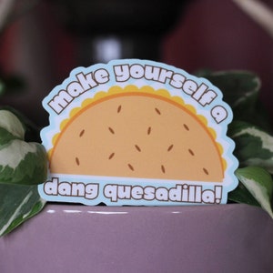May include: A blue and yellow sticker with a cartoon quesadilla and the text "make yourself a dang quesadilla!"