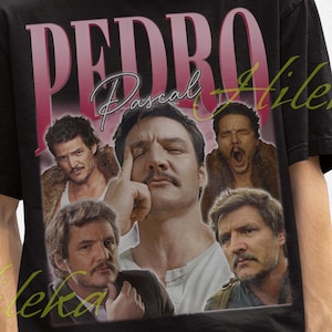 May include: Black t-shirt with a vintage-style graphic of actor Pedro Pascal. The graphic features multiple images of Pascal in different poses and includes the text "PEDRO Pascal".