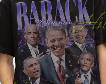 May include: Black t-shirt featuring multiple images of Barack Obama with the word "BARACK" in purple. The shirt has a vintage style and is worn by a person wearing a black bucket hat.
