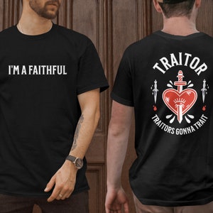 May include: Two black t-shirts with different designs. The front shirt says "I'm a Faithful". The back shirt has a white graphic of a heart with a sword through it and the text "Traitor, Traitors Gonna Trait".