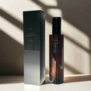 May include: A black box with the text "28" Luxury Room Spray 100ml. A brown glass bottle with a black cap and the text "No. 97" on the label.