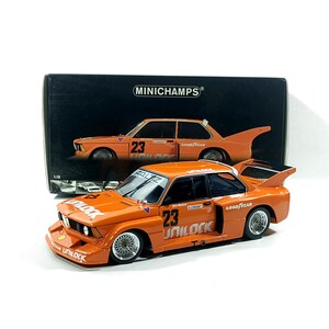 May include: Orange diecast model race car with the number 23 and sponsor logos. The model is in front of a black box with a picture of the car. The car has a spoiler and racing tires. The model is approximately 7 inches long.
