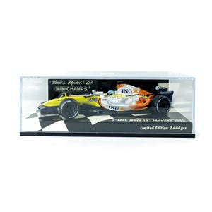 May include: A model race car in a clear display case. The car is yellow, orange, and black with sponsor logos and black wheels. The display base is a black and white chequered pattern. The case has text that reads "Paul's Model Art MINICHAMPS".