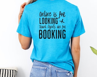 May include: A turquoise blue t-shirt with black text that reads "Online is for LOOKING Travel Agents are for BOOKING" with a small airplane icon.