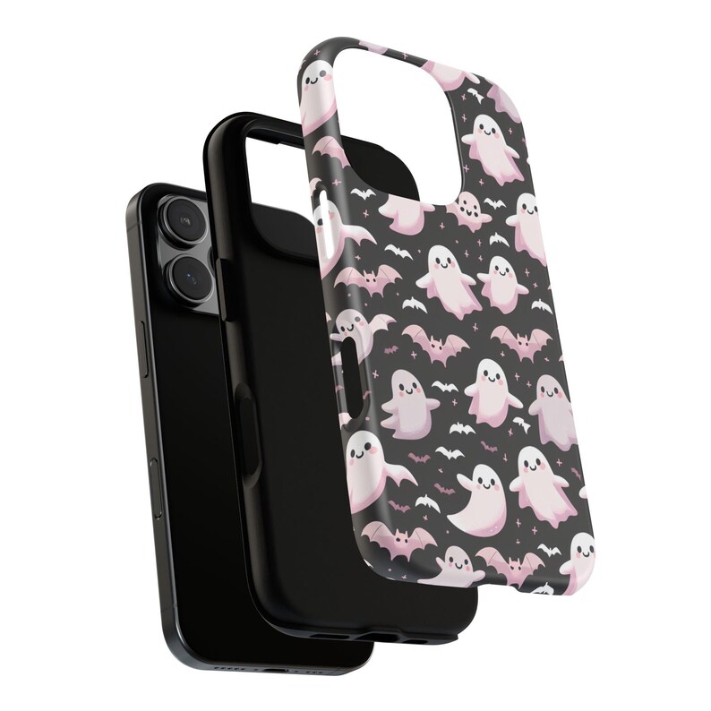May include: A black phone case with a pink and white ghost and bat pattern. The case is shown in three parts, with the phone inside a black protective case and the patterned cover on top. The design is a Halloween theme.