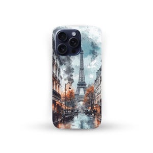 May include: A phone case featuring a watercolor painting of the Eiffel Tower in Paris. The artwork depicts a street scene with buildings, trees, and a wet road. The color palette includes shades of gray, brown, and orange.