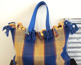 Medium size loom-woven textile tote bag in shades of blue to carry over the shoulder.