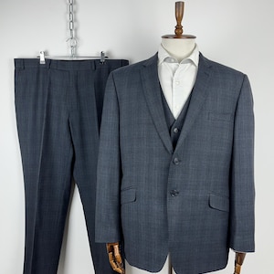 May include: A dark grey pinstripe suit with a matching waistcoat. The suit jacket has a two-button closure and the waistcoat has a three-button closure.