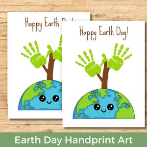 May include: Two white cards with a drawing of a smiling Earth with a tree made of handprints. The text "Happy Earth Day!" is written in brown. The bottom of the image reads "Earth Day Handprint Art".