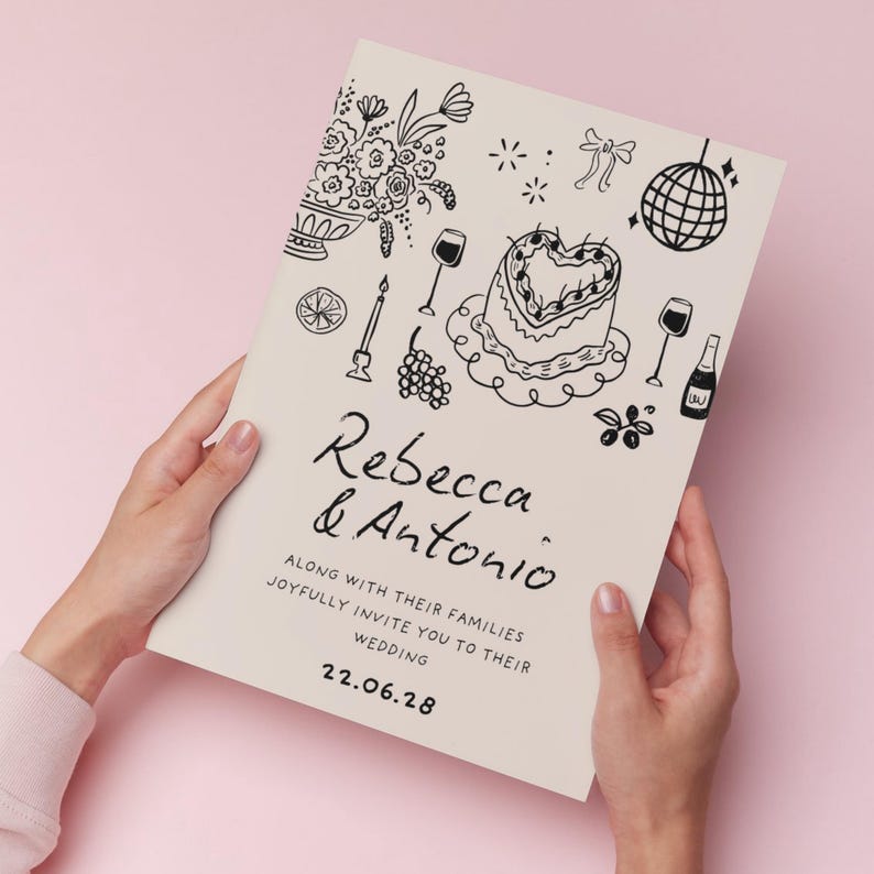 K&ouml;nnte beinhalten: Eine rechteckige Hochzeitseinladungskarte in Creme mit schwarzen Strichzeichnungen eines herzf&ouml;rmigen Kuchens, einer Discokugel, Blumen und Weingl&auml;sern. Der Text lautet Rebecca & Antonio along with their families joyfully invite you to their wedding 22.06.28.