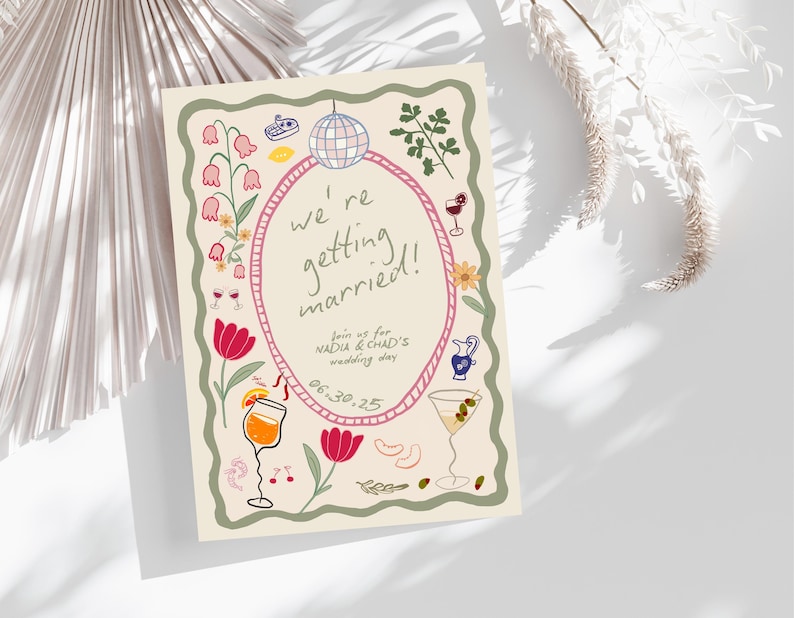 May include: A rectangular wedding invitation card with a cream background, featuring a pink oval frame containing the text 'we're getting married!', 'join us for NADIA & CHAD'S wedding day', and '06.30.25'. The border is decorated with colorful illustrations.