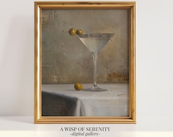 Peut inclure: Une peinture d'un verre à martini avec des olives sur une nappe blanche. Le verre est rempli d'un liquide clair et les olives sont vertes. La peinture est encadrée d'or.