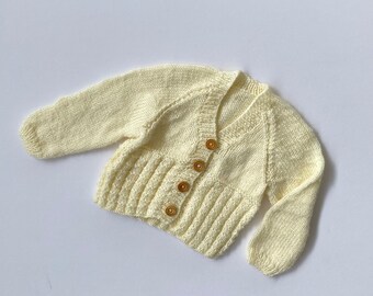 Vintage hand knitted baby cardigan in cream with wooden button detail, size 6-12m