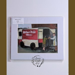 May include: An original painting of a bread van with the words "Mother's Pride Bread" on the side. The artwork depicts two people interacting near the van. The painting is framed in white and signed by Annie Coyle Art.