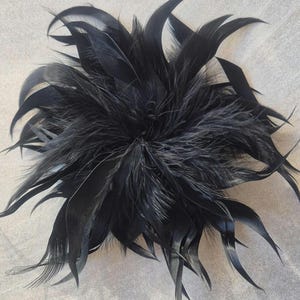 May include: A white ceramic mug with a black handle and the text "But First, Coffee" in a handwritten style. The mug is on a white surface. The mug is 4 inches tall.